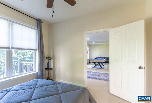 carpeted bedroom with pool table, a ceiling fan, and baseboards