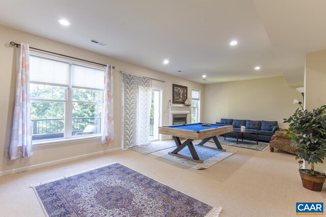 recreation room featuring carpet floors, recessed lighting, visible vents, and a fireplace