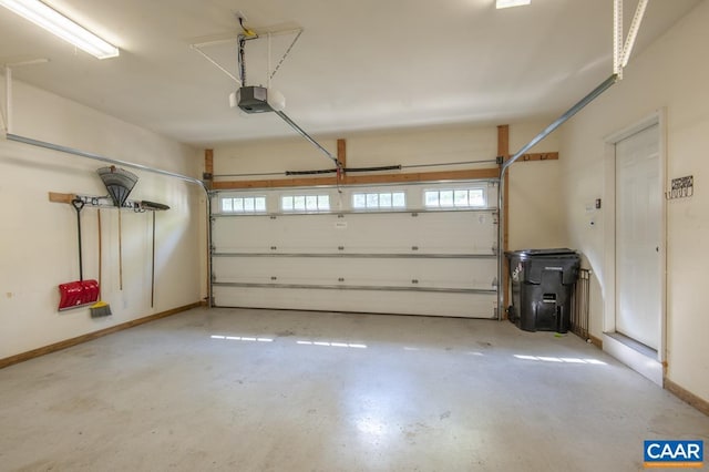 garage with baseboards and a garage door opener