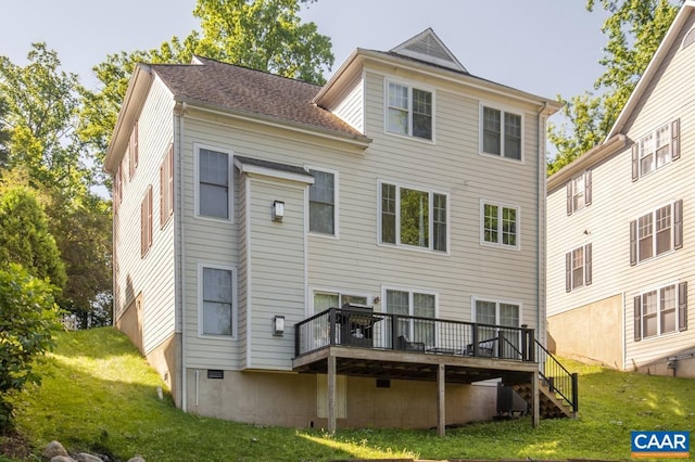 rear view of house with a wooden deck, stairway, and a yard