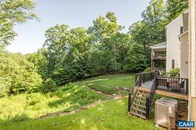 view of yard featuring central air condition unit and a wooden deck