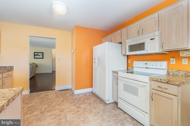 kitchen featuring light brown cabinets, white appliances, and light countertops