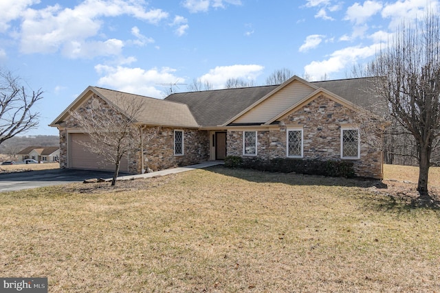 ranch-style house featuring a front yard, an attached garage, and driveway