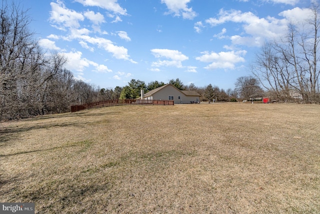 view of yard with a rural view and fence