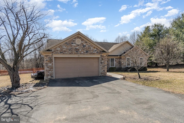 ranch-style home featuring stone siding, an attached garage, driveway, and fence