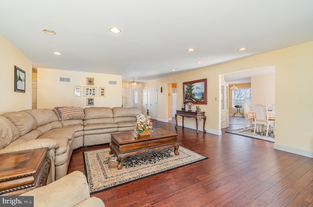 living room with recessed lighting, visible vents, dark wood-style flooring, and baseboards