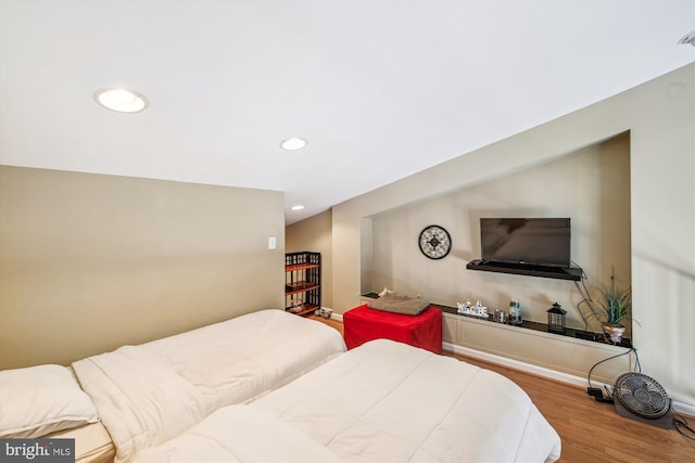 bedroom with wood finished floors and recessed lighting