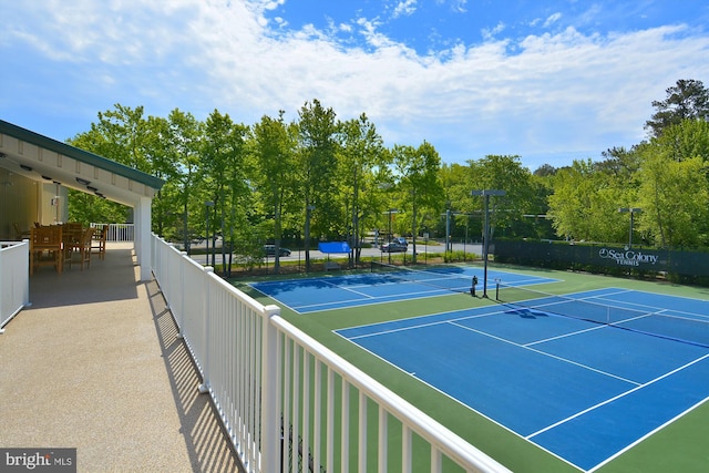 view of tennis court with fence