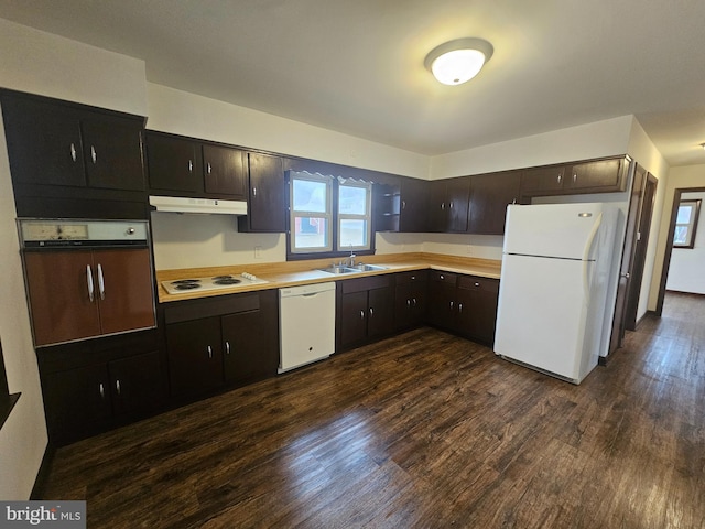 kitchen with white appliances, dark wood finished floors, light countertops, dark brown cabinets, and under cabinet range hood