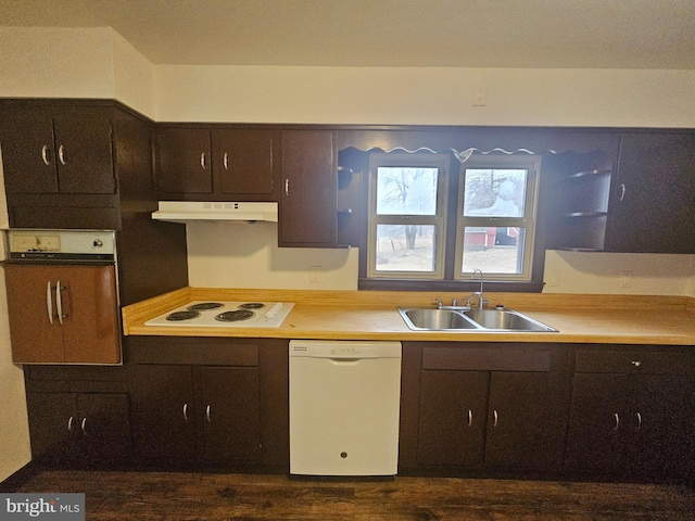 kitchen featuring white appliances, a sink, under cabinet range hood, and dark brown cabinets