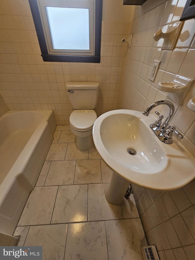 full bathroom with a shower, visible vents, toilet, a sink, and a bath