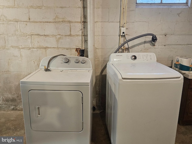 washroom featuring laundry area and separate washer and dryer