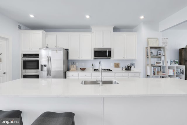 3802 Rock Spring Dr, Upper Marlboro, MD 20772 - kitchen with a sink, appliances with stainless steel finishes, white cabinets, and a large island