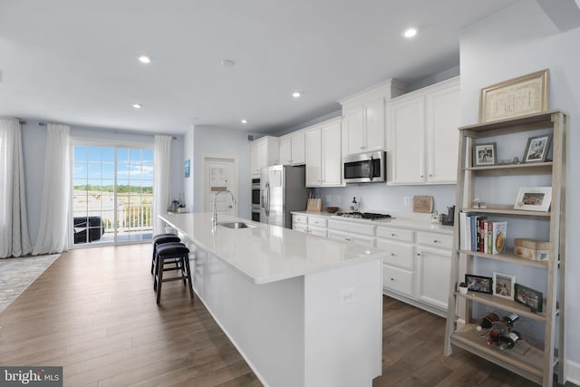 3802 Rock Spring Dr, Upper Marlboro, MD 20772 - kitchen with white cabinets, appliances with stainless steel finishes, a sink, a kitchen island with sink, and dark wood-style floors