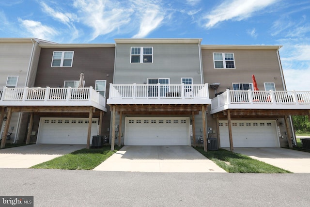 3802 Rock Spring Dr, Upper Marlboro, MD 20772 - rear view of property featuring a garage, driveway, and central AC unit