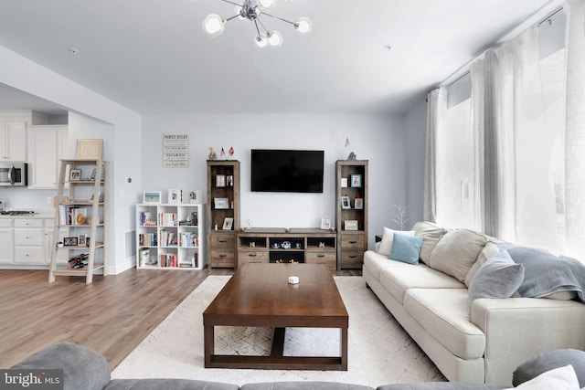 3802 Rock Spring Dr, Upper Marlboro, MD 20772 - living room featuring baseboards, a notable chandelier, and light wood-style floors