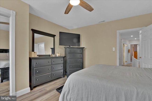 bedroom featuring baseboards, visible vents, ceiling fan, and wood finished floors