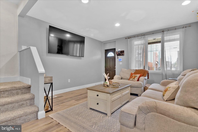 living area with stairway, recessed lighting, light wood-style flooring, and baseboards