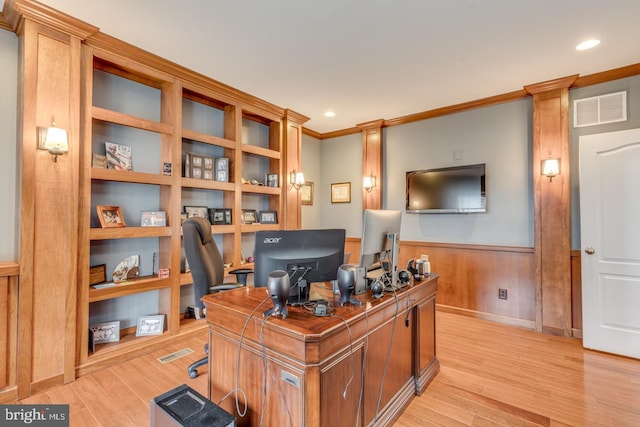 office space featuring light wood finished floors, visible vents, ornamental molding, and wainscoting