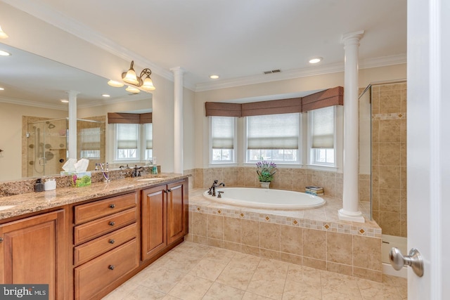 full bath featuring a stall shower, decorative columns, and a sink