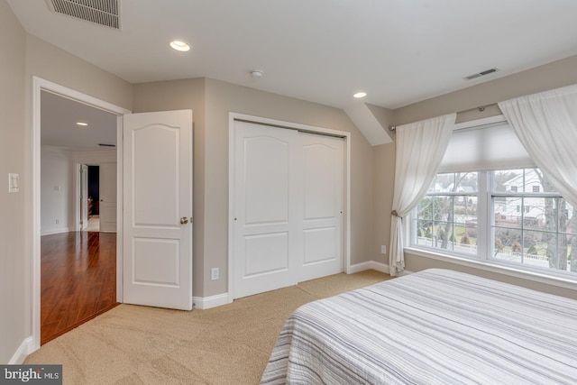 bedroom featuring recessed lighting, visible vents, a closet, and carpet flooring