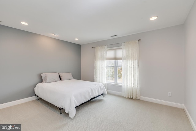 bedroom with recessed lighting, light carpet, and baseboards