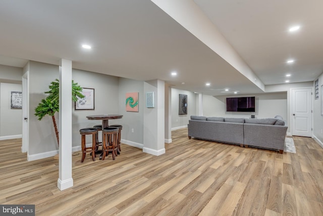 living area with recessed lighting, light wood-type flooring, and baseboards