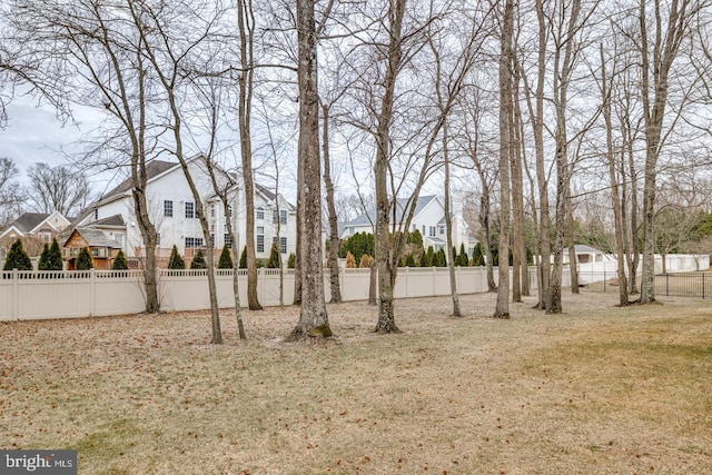 view of yard featuring fence private yard and a residential view