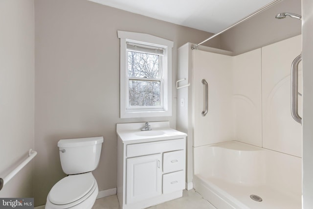 full bathroom with baseboards, toilet, a stall shower, and vanity