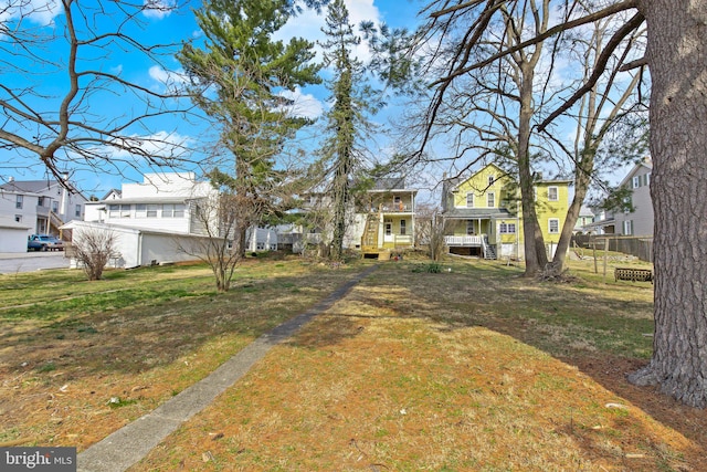 view of yard featuring fence and a residential view