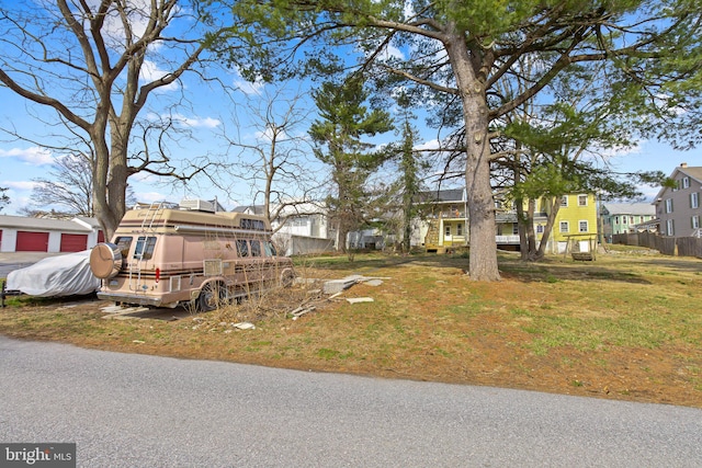 view of front of home featuring a residential view and fence