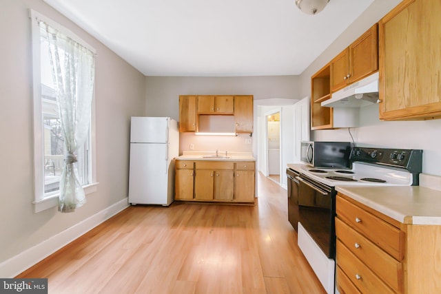 kitchen with open shelves, freestanding refrigerator, a sink, electric range oven, and under cabinet range hood