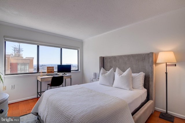 bedroom with a textured ceiling, baseboards, wood finished floors, and crown molding