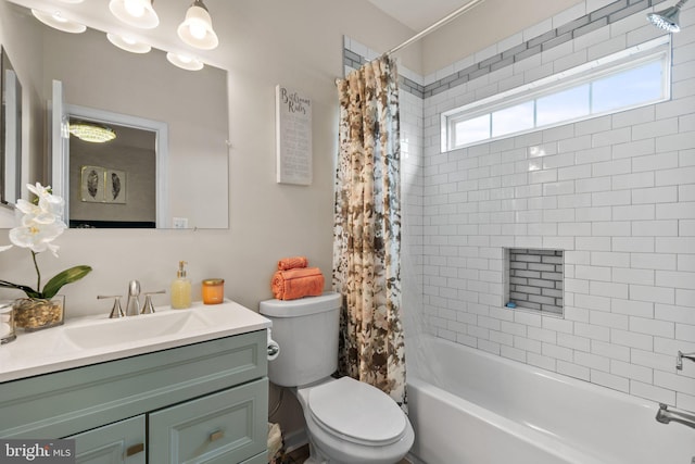 bathroom featuring toilet, shower / tub combo, and vanity