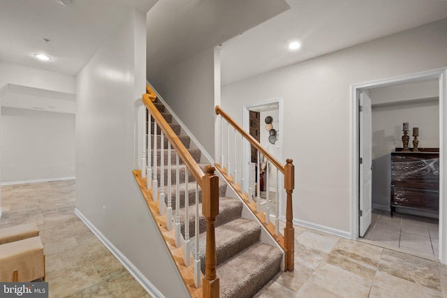 staircase with baseboards and recessed lighting