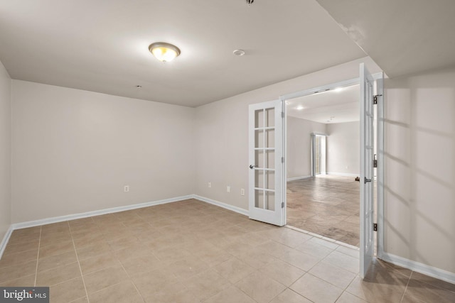 empty room with french doors and baseboards