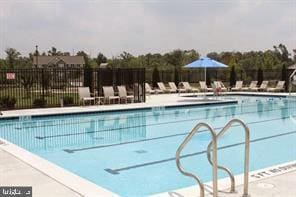 pool with fence and a patio