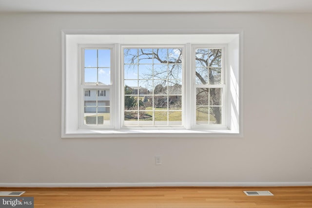 details featuring visible vents, baseboards, and wood finished floors