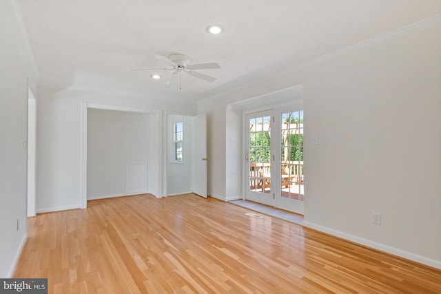 interior space with light wood finished floors, ceiling fan, baseboards, and ornamental molding