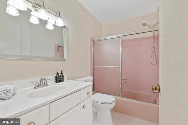 full bath with tile patterned floors, toilet, vanity, and bath / shower combo with glass door