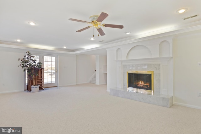 unfurnished living room with visible vents, stairway, carpet floors, a fireplace, and baseboards