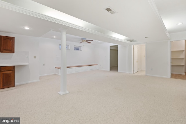 finished basement with baseboards, visible vents, recessed lighting, light carpet, and crown molding