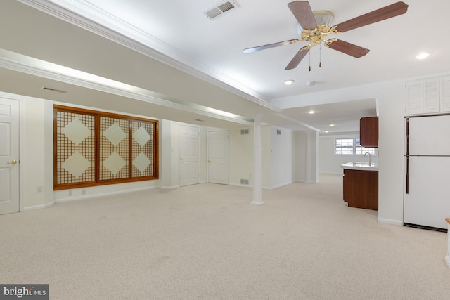 unfurnished living room featuring visible vents, baseboards, light colored carpet, ornamental molding, and recessed lighting