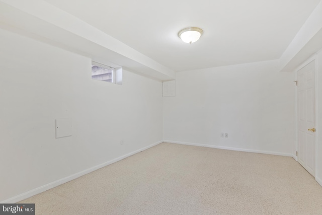 below grade area featuring carpet flooring and baseboards