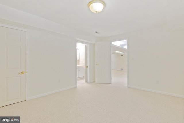 empty room featuring baseboards and carpet floors