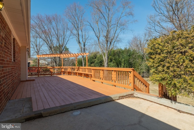 wooden deck featuring a patio area and a pergola