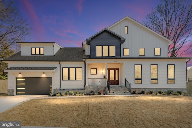 modern farmhouse featuring driveway, a garage, a shingled roof, a porch, and board and batten siding