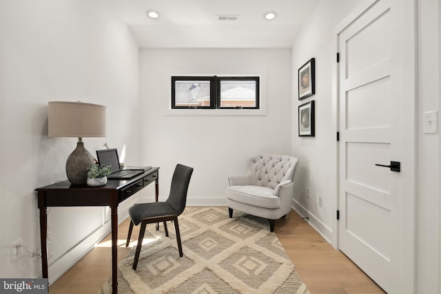 office area featuring light wood finished floors, recessed lighting, visible vents, and baseboards