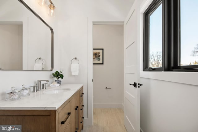 bathroom with vanity and baseboards