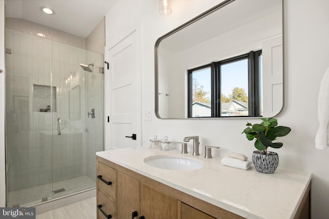 bathroom featuring recessed lighting, a shower stall, and vanity